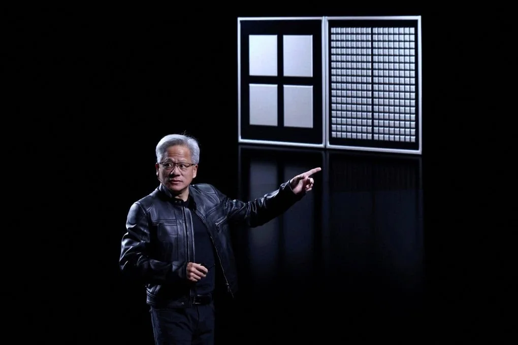 Nvidia taps 2 young Chinese AI experts as CEO Jensen Huang explains AI research strategy in a modern office setting.