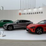 Xiaomi Tesla killer SU7 electric cars showcased in green, grey, and red colors during official launch event.