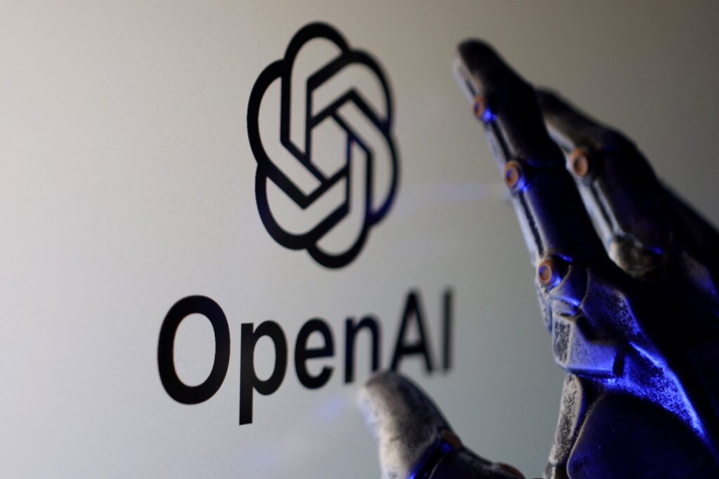 OpenAI and Microsoft AGI Duel – A robotic hand touching the OpenAI logo symbolizing the future of artificial intelligence.
