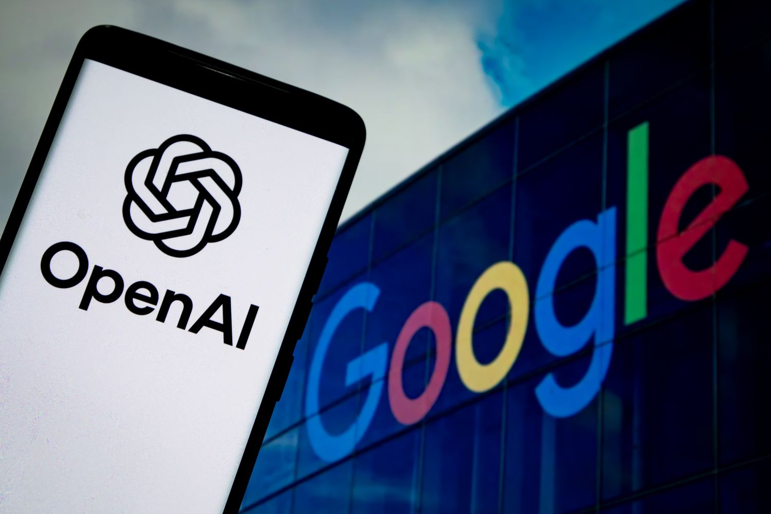 Two smartphones side by side, one displaying OpenAI and the other showing Google, symbolizing OpenAI’s use of Google’s AI chips.