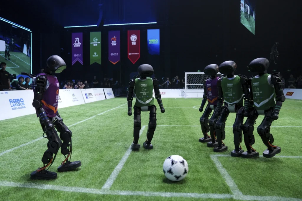 Humanoid robots playing football during China's first fully autonomous AI robot football match