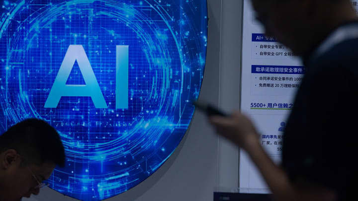 People walk past a display showcasing China’s latest AI model at a tech exhibition.