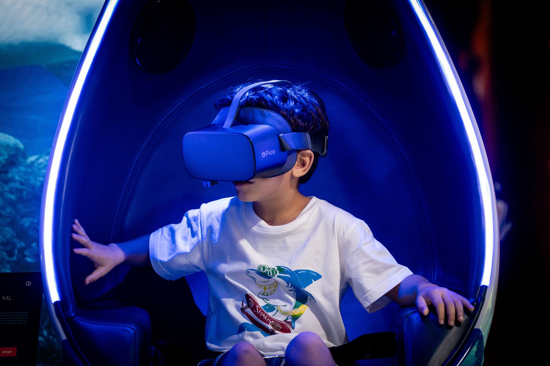 A young boy wearing a VR headset in a futuristic pod, exploring AI-powered virtual experiences — symbolizing AI friendship for kids.