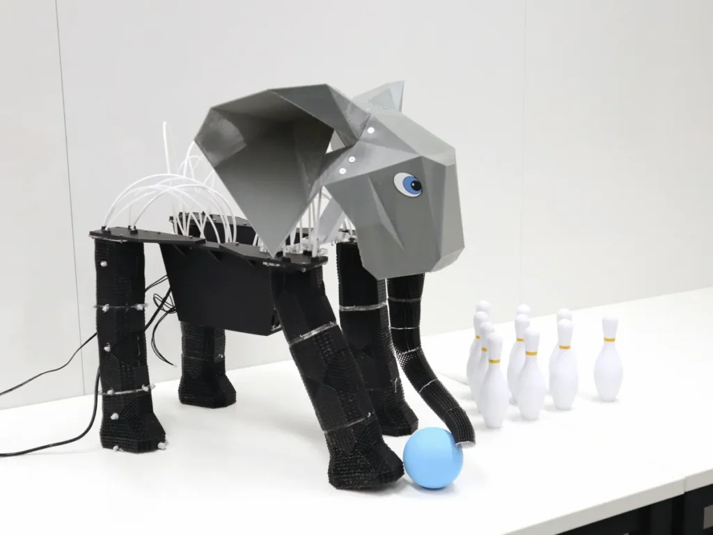 First of its kind robot elephant playing bowling with a blue ball and pins