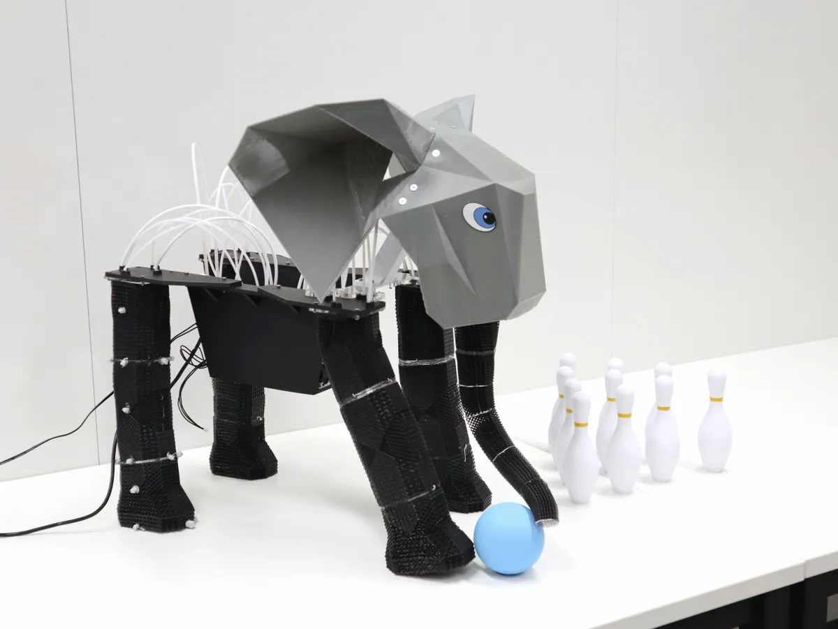 First of its kind robot elephant playing bowling with a blue ball and pins