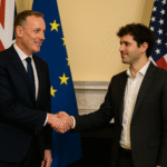 UK government official and OpenAI executive shake hands after signing AI partnership deal, with national flags in background.