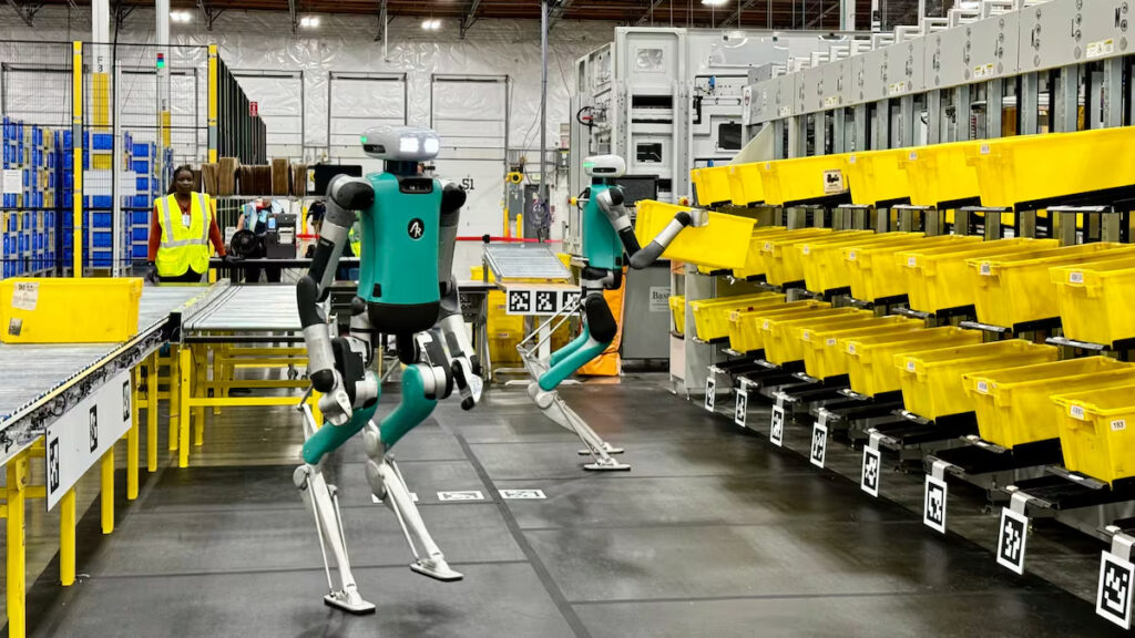 Autonomous robots in the UK working inside an Amazon warehouse, handling packages without human assistance