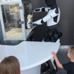 Tesla Optimus humanoid robot serving popcorn with precision