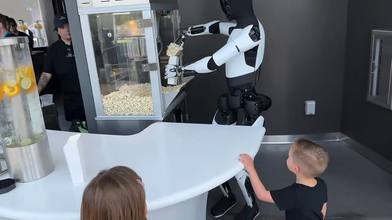 Tesla Optimus humanoid robot serving popcorn with precision