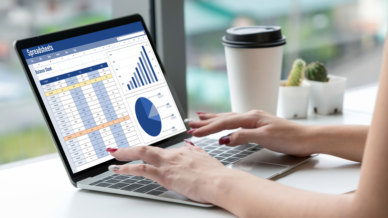 Person working on Excel spreadsheet with charts and balance sheet, illustrating Excel automation with AI.
