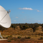 A large white satellite dish in rural Australia representing the expansion of satellite internet Australia services under Amazon's Project Kuiper.