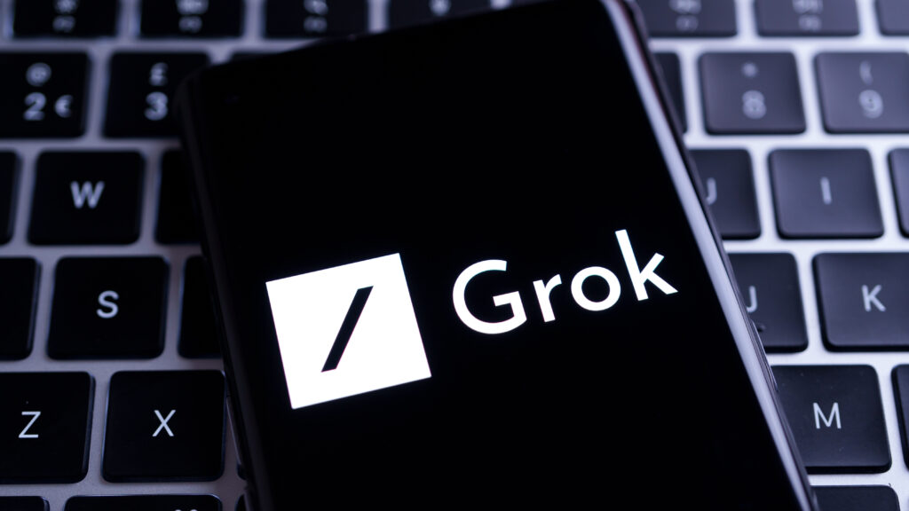 Grok logo displayed on smartphone screen showcasing Grok Imagine text to video AI innovation by Elon Musk.