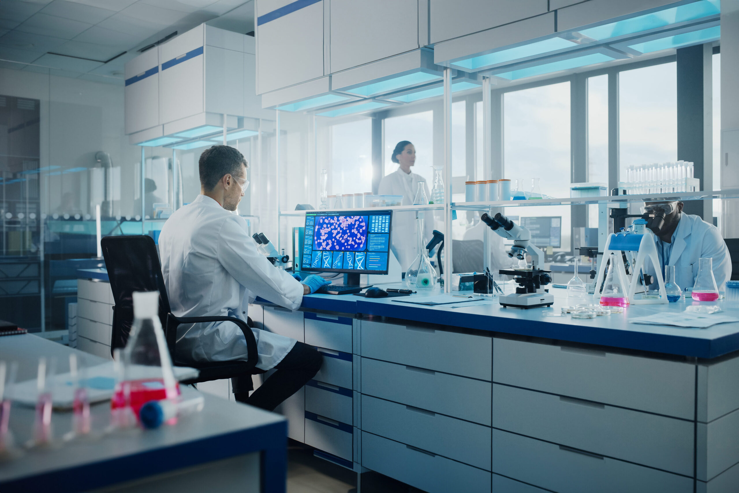 Scientist analyzing molecular structures on a computer screen in a high-tech lab during the CuspAI funding breakthrough.