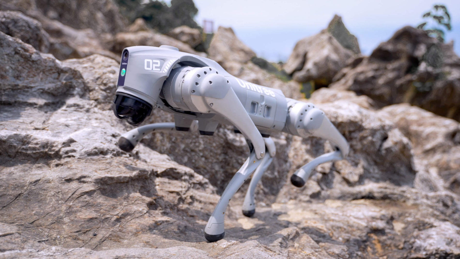 A mechanical robotic dog by Unitree navigating rocky terrain, symbolizing rising innovation behind Chinese robot stocks.