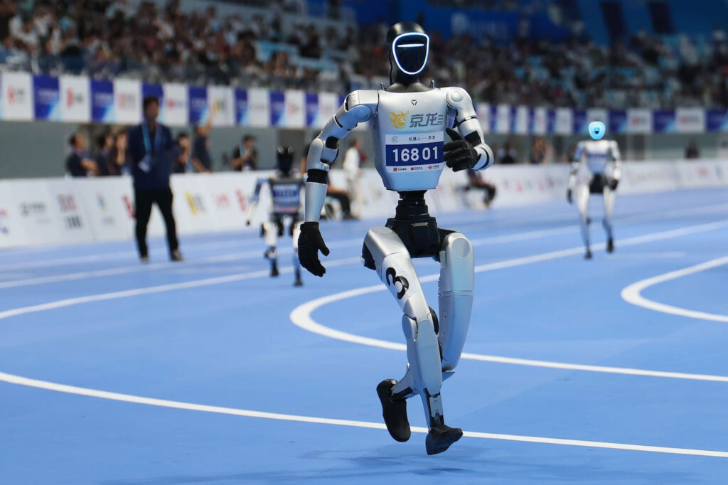 Chinese humanoid robots competing in running challenge at the World Humanoid Robot Games in Beijing.