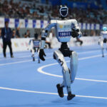 Chinese humanoid robots competing in running challenge at the World Humanoid Robot Games in Beijing.