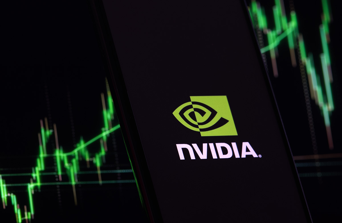 Nvidia logo displayed on a smartphone screen with stock market charts in the background, representing Nvidia Stock rise and AI chip market growth.