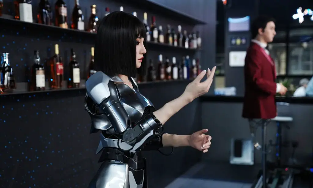 Humanoid service robot assisting customers at the front desk of a restaurant during the Robot Shopping Festival inside the world’s first humanoid robot 4S store, Robot Mall in Beijing.