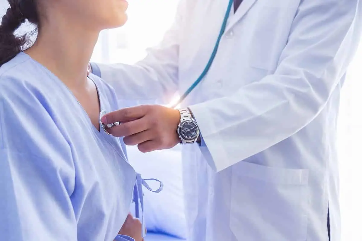 Doctor using an AI stethoscope on a patient to detect heart conditions in just 15 seconds.