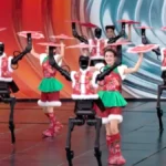 Humanoid robot performing synchronized robot dance with human dancers on stage”