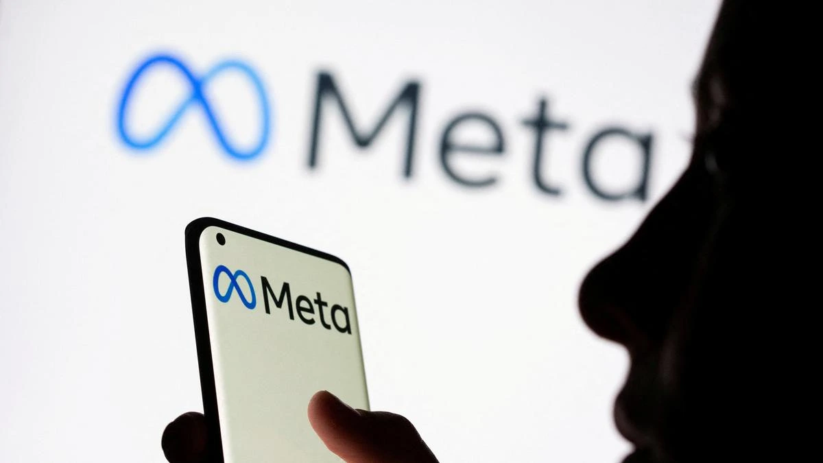A teenager using a mobile with the Meta logo on the mobile screen, symbolizing new safety measures restricting Meta AI chatbots for teens.