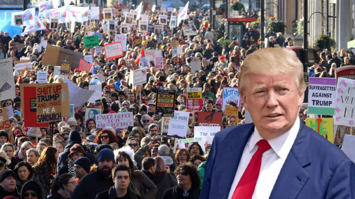 Thousands of people in London holding banners during the Trump UK state visit protest.