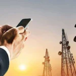 Businessman holding smartphone with telecom towers in background amid nationwide network shutdown Afghanistan telecom blackout
