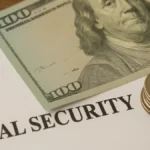 A close-up of a Social Security document with U.S. currency and coins symbolizing the 2026 COLA benefit increase.