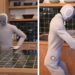 1X NEO humanoid robot cleaning a kitchen counter and loading dishes into a dishwasher, demonstrating home automation capabilities.