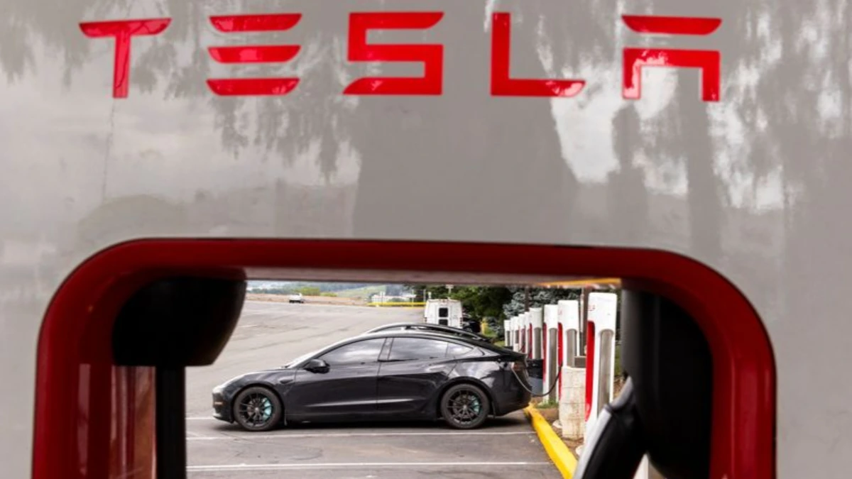 A street in Austin with autonomous electric cars from the Tesla robotaxi fleet operating during daytime traffic.