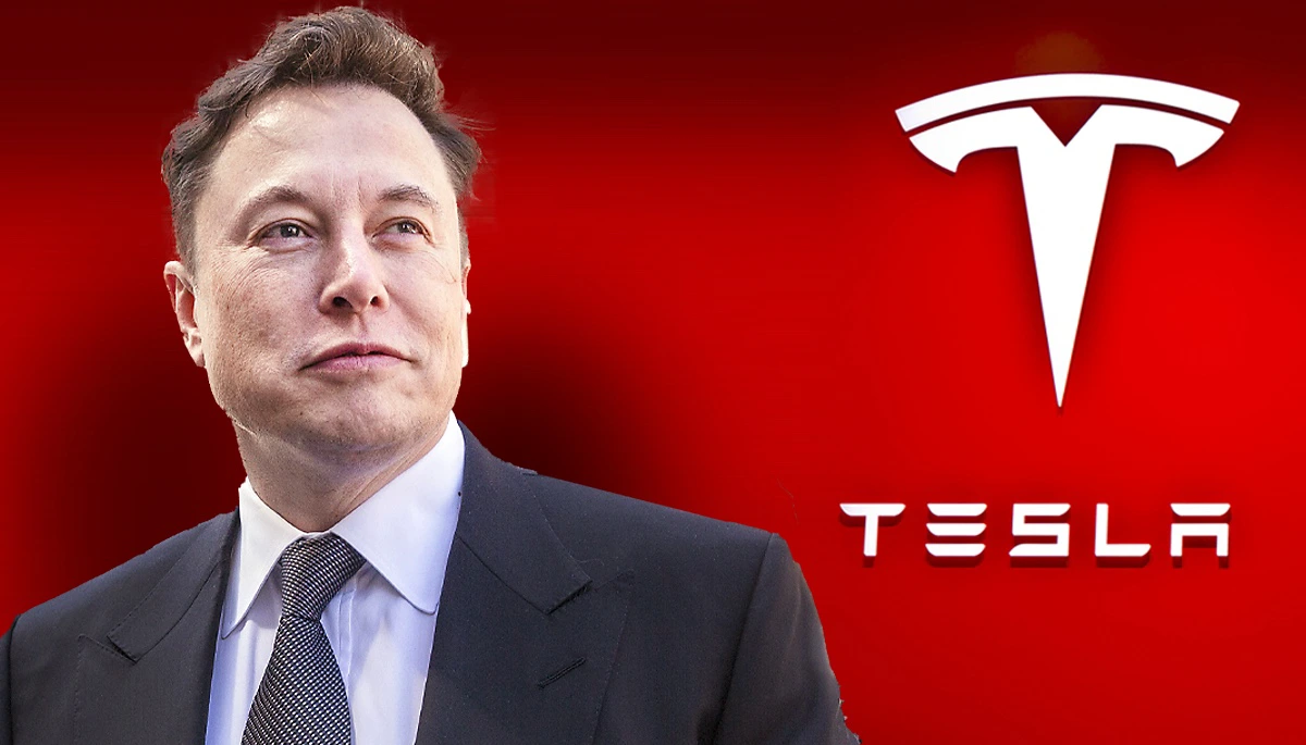 Elon Musk stands in front of Tesla logo as Tesla board urges shareholders to approve massive pay package