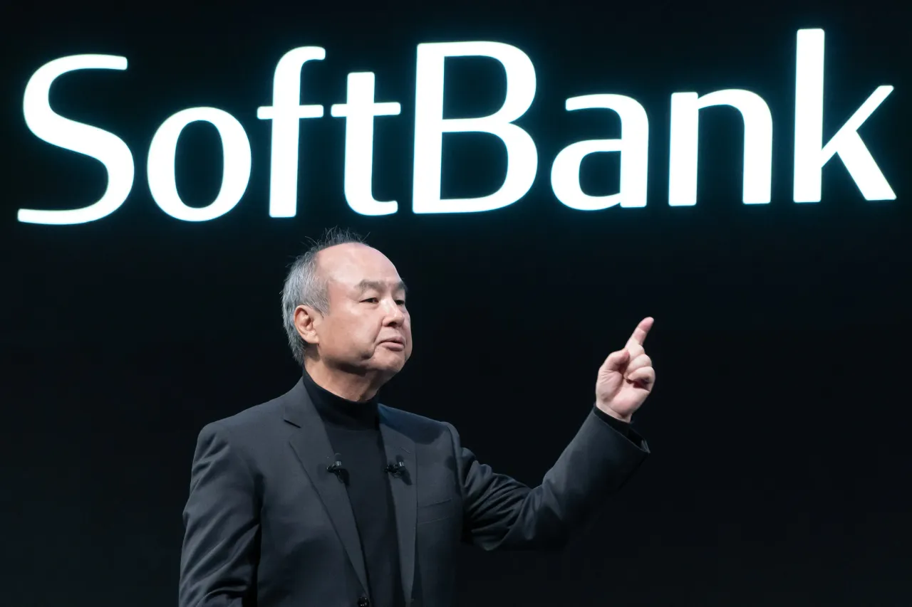 SoftBank CEO Masayoshi Son announces AI investment plans while Nvidia chips are displayed on a screen