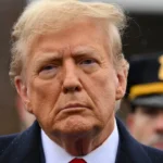 Trump looks at financial charts showing declining net worth, symbolizing his $1.1 billion drop in wealth