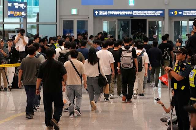 South Korean workers applying for business visas at the U.S. Embassy in Seoul