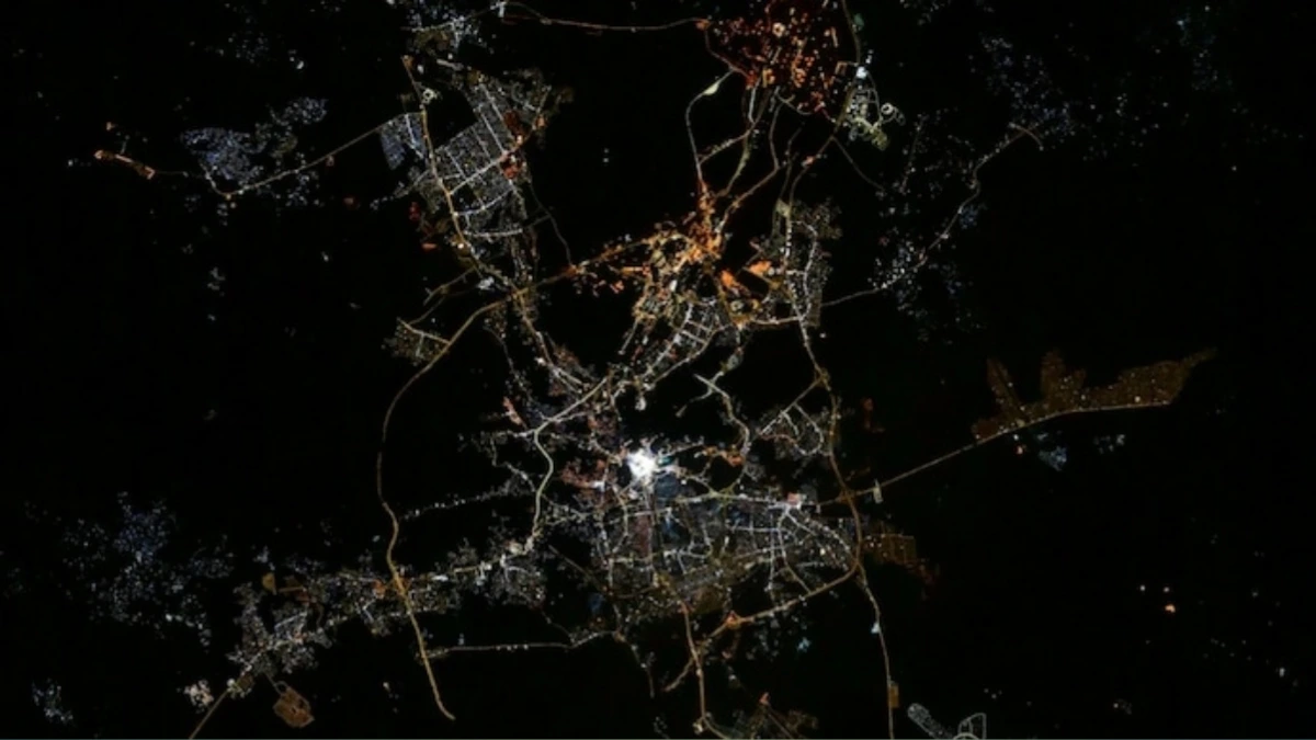 Mecca visible from space at night, showing Kaaba glowing in the center of the city from orbit