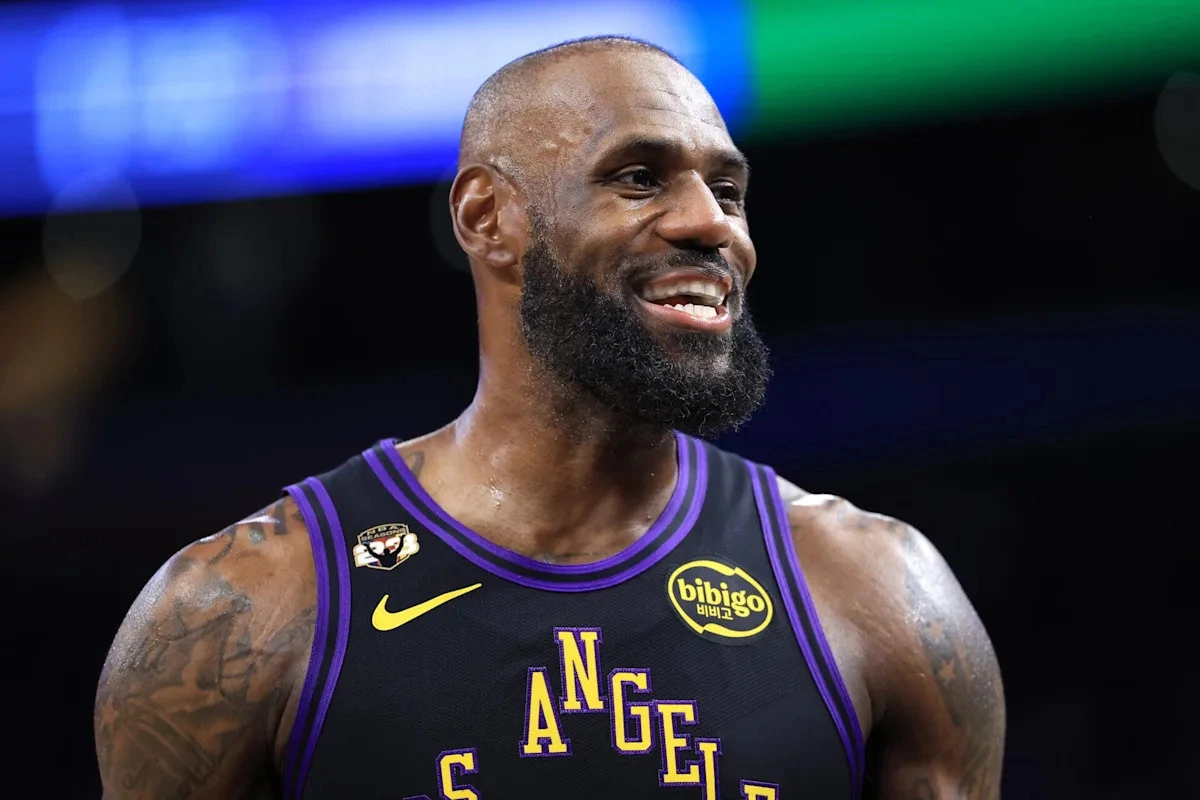 LeBron James smiles during an NBA game while wearing a Los Angeles Lakers jersey ahead of his reported move to the Philadelphia 76ers.