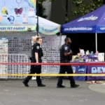 Seattle police officers investigate the scene of the Seattle festival shooting at Seattle Center after gunfire during the Bite of Seattle event left two people dead and five injured.