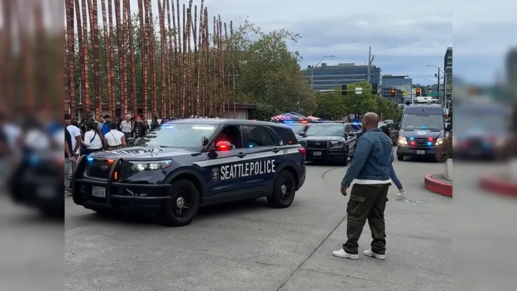 Seattle police officers investigate the scene of the Seattle festival shooting at Seattle Center after gunfire during the Bite of Seattle event left two people dead and five injured.