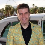 Perez Hilton posing in front of a vintage car before his hospitalization following a reported livestream mental health crisis.