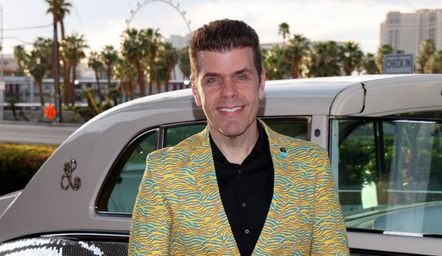 Perez Hilton posing in front of a vintage car before his hospitalization following a reported livestream mental health crisis.