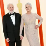 Jamie Lee Curtis and Christopher Guest posing together at a formal event