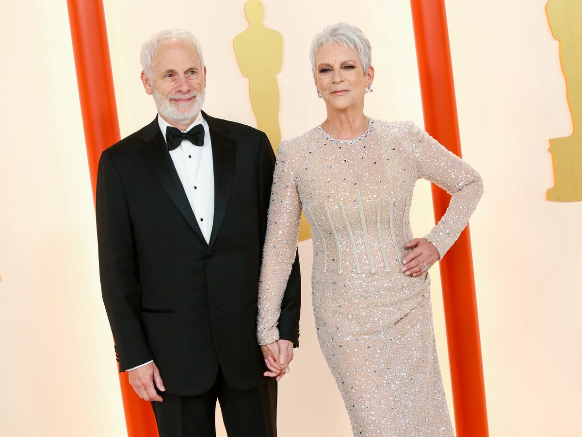 Jamie Lee Curtis and Christopher Guest posing together at a formal event